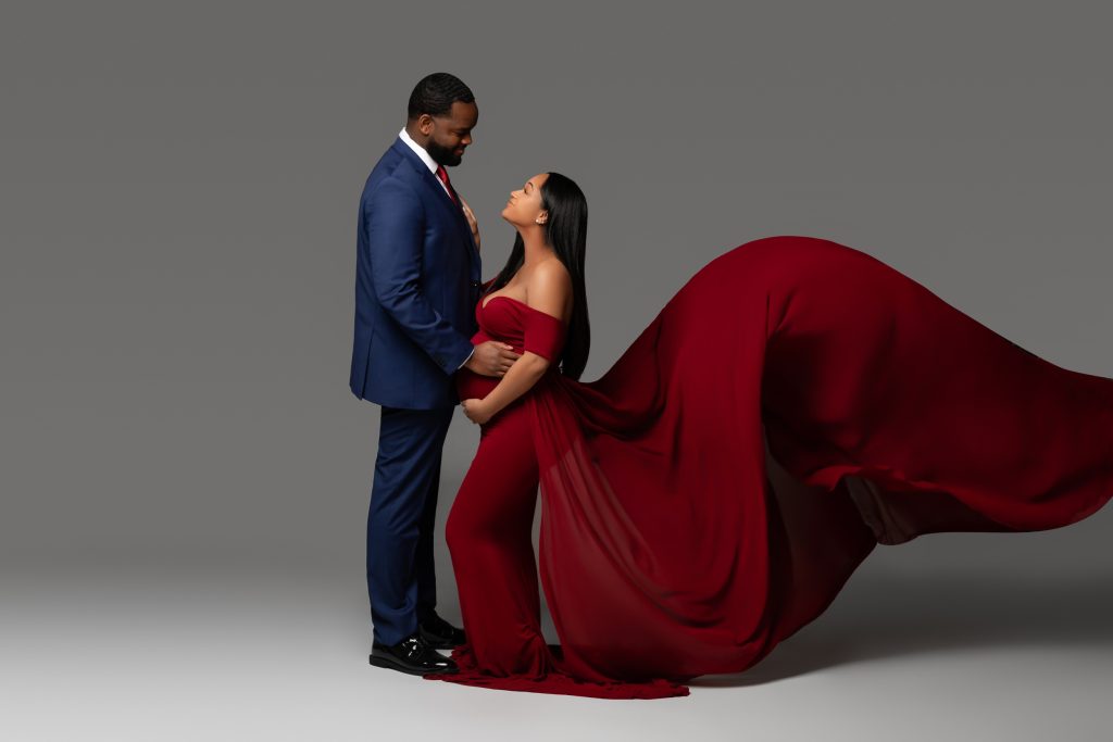 man-with-pregnant-woman-in-crimson-gown