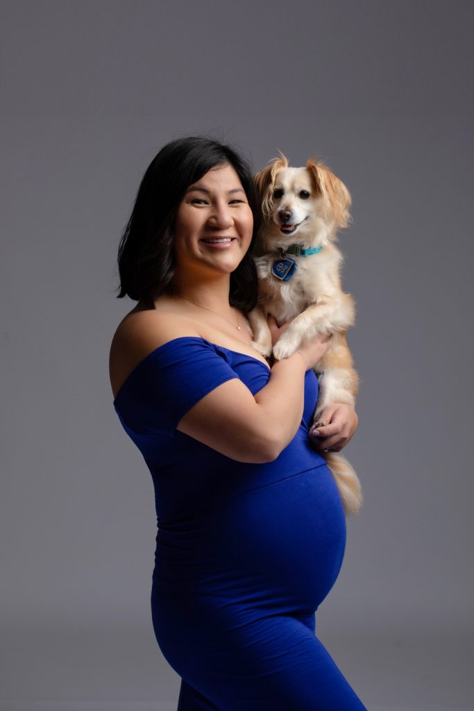 pregnant-woman-in-gown-holding-dog