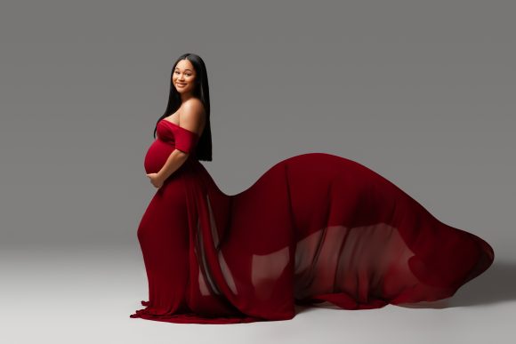 woman-in-red-flowing-maternity-gown